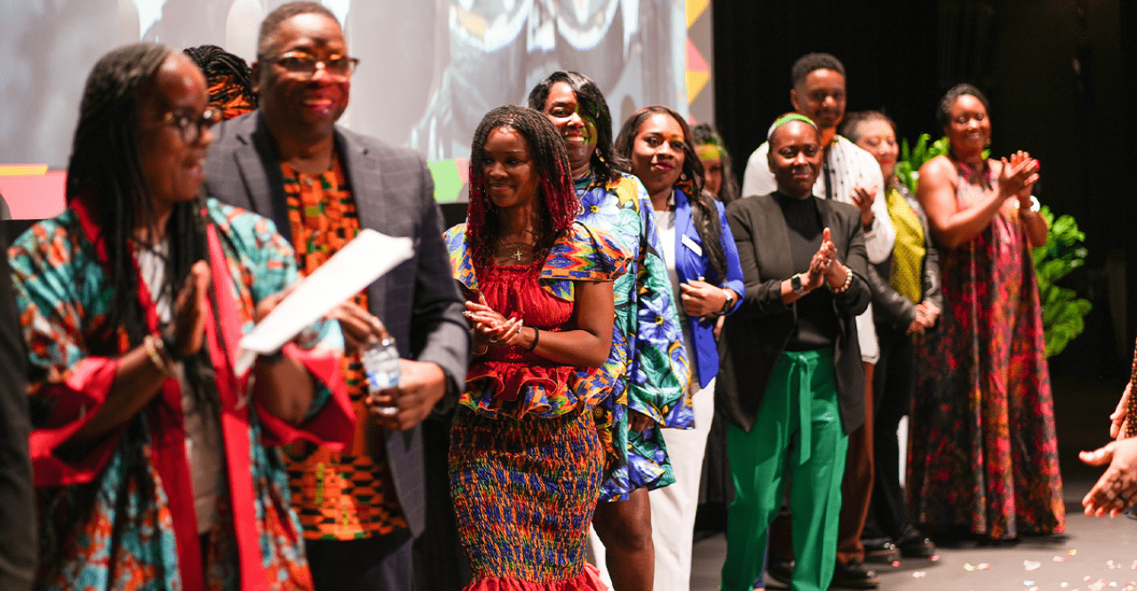 The ADES 2024 attendees being applauded onstage.