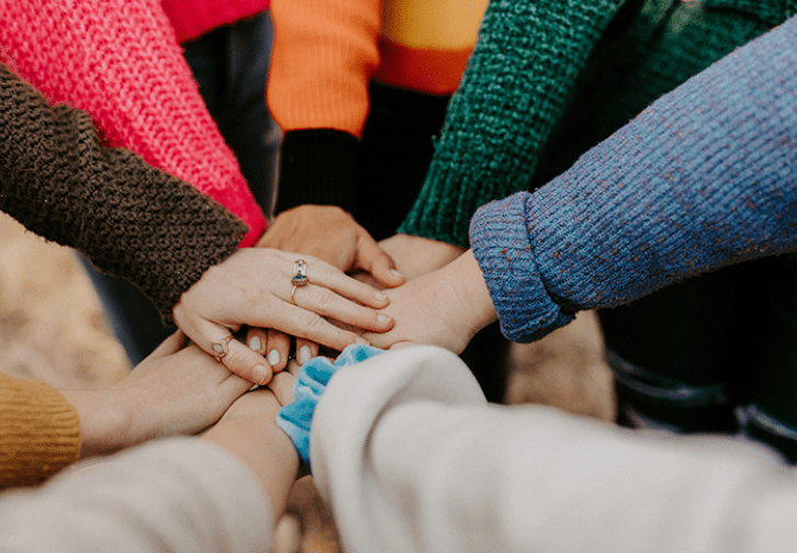 a group of hands in a circle