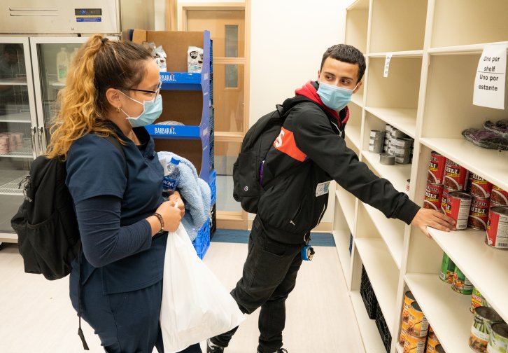 students taking food off shelf