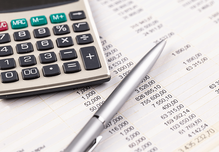 spreadsheet with pen and calculator